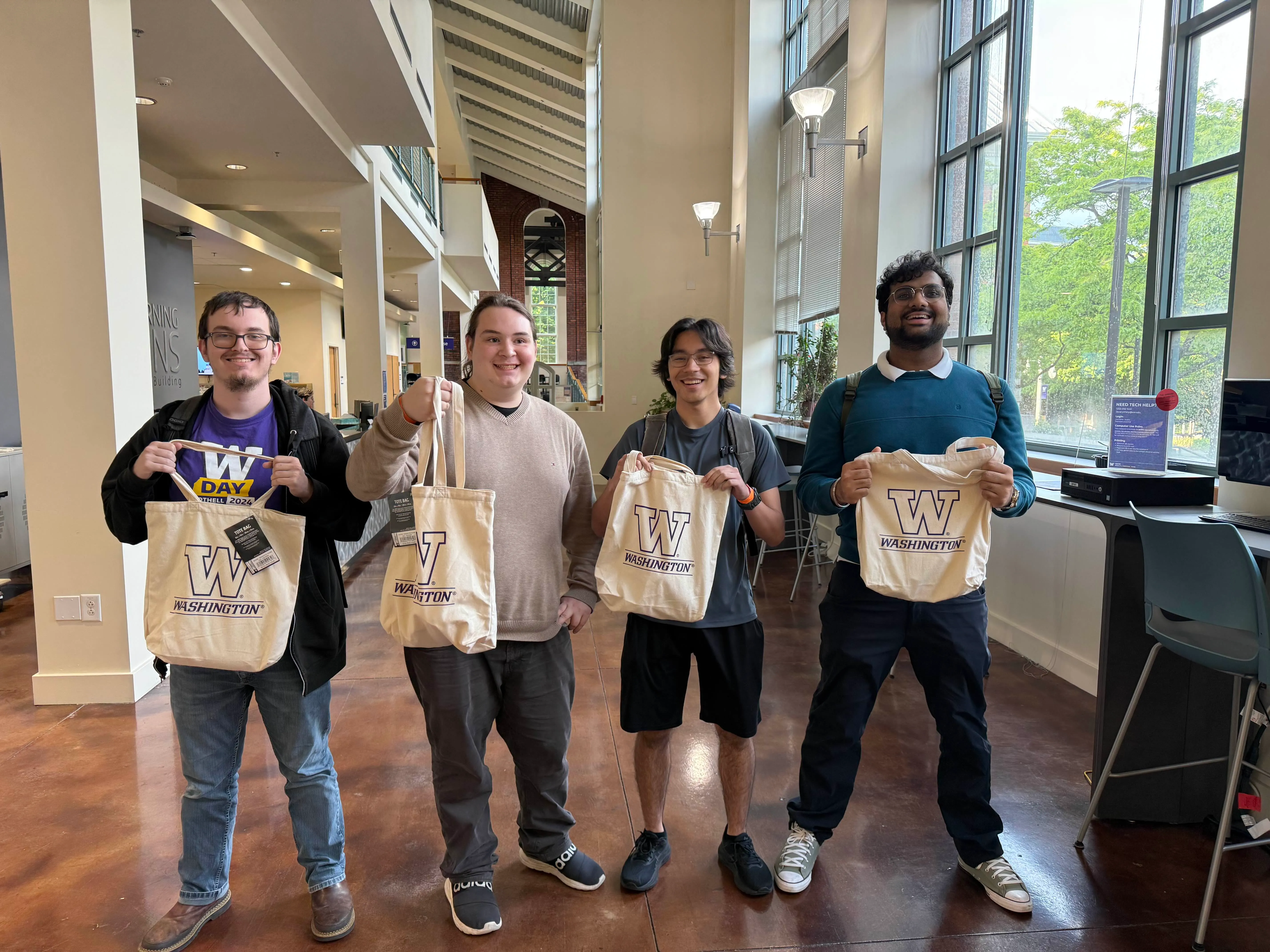 Picture of the development team holding their winning tote bags.