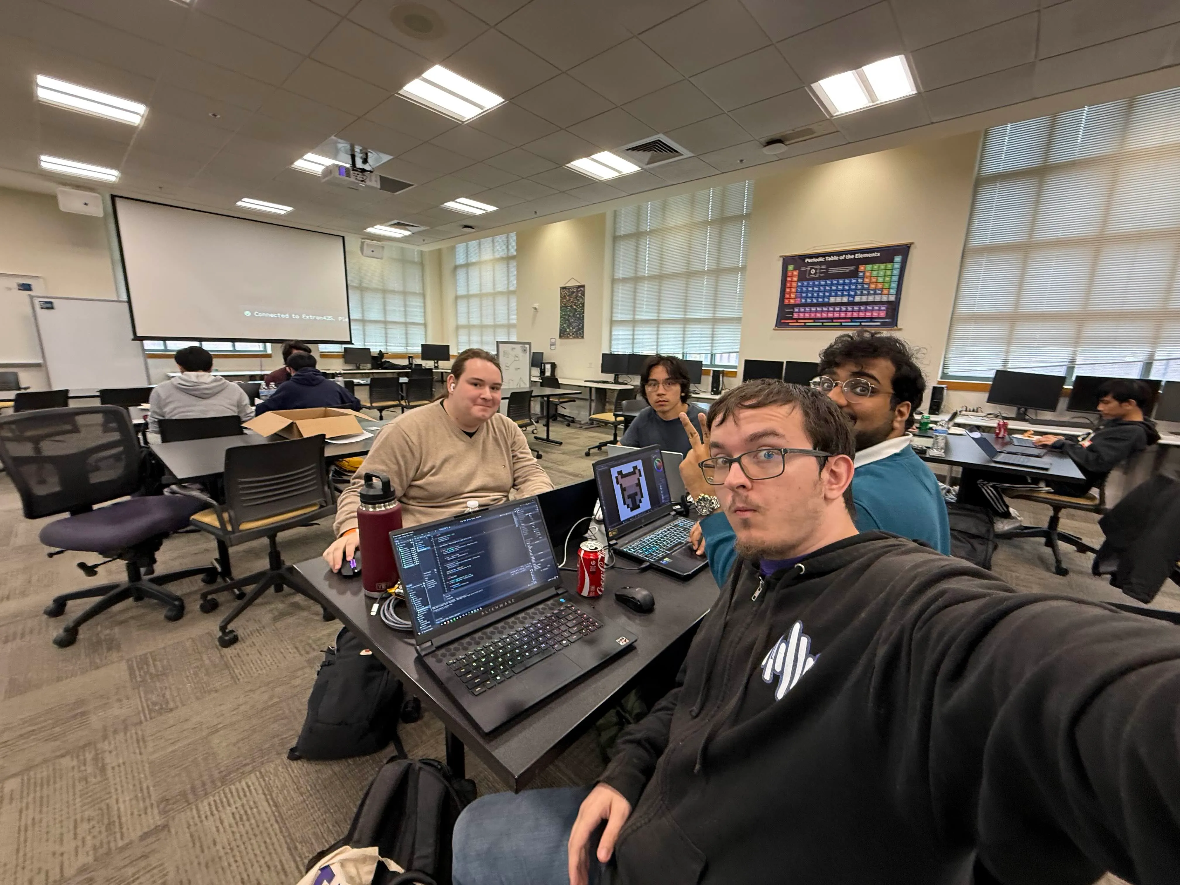 Picture of the development team working on Catcha'd during the hackathon hours.